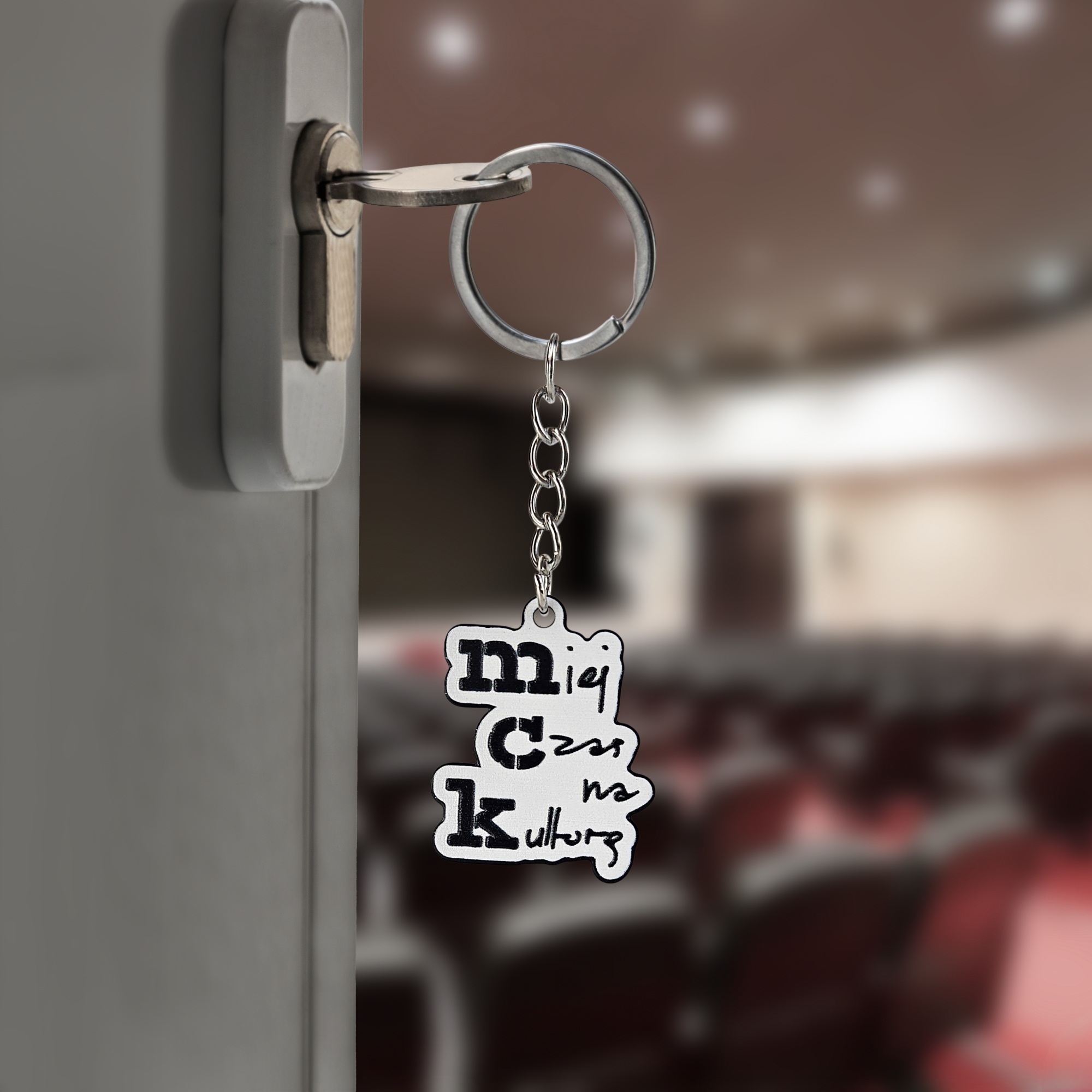 Black and white metal keychain for the Municipal Cultural Center in Gorzów Wielkopolski. Polish manufacturer DECARD