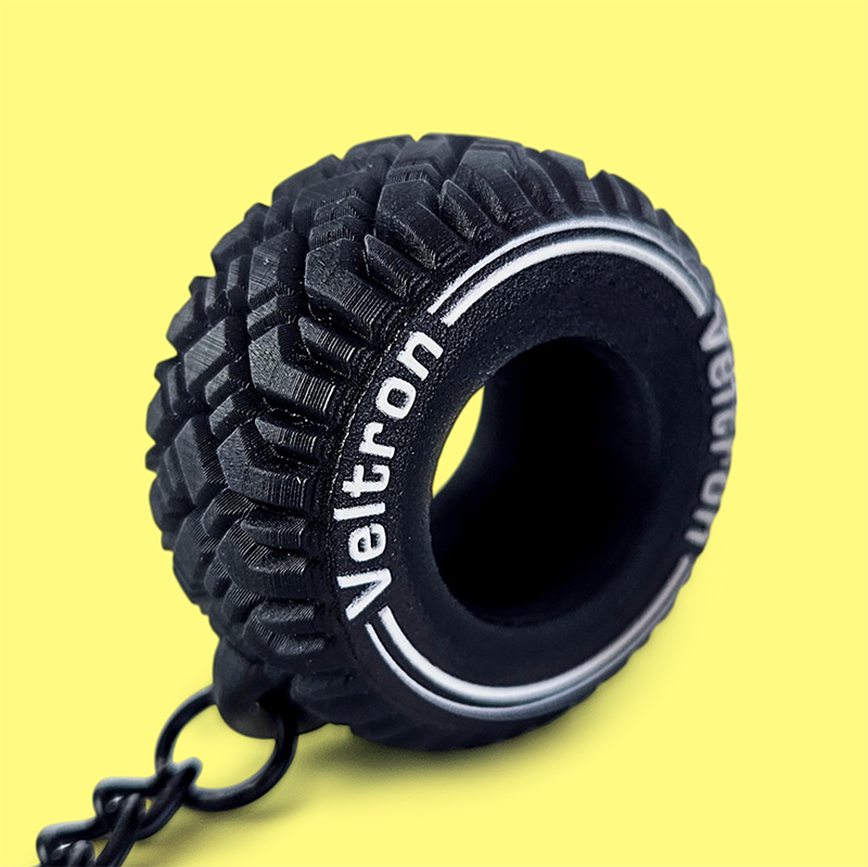 3D keychain, black tire with white logo, tread texture, Polish manufacturer DECARD