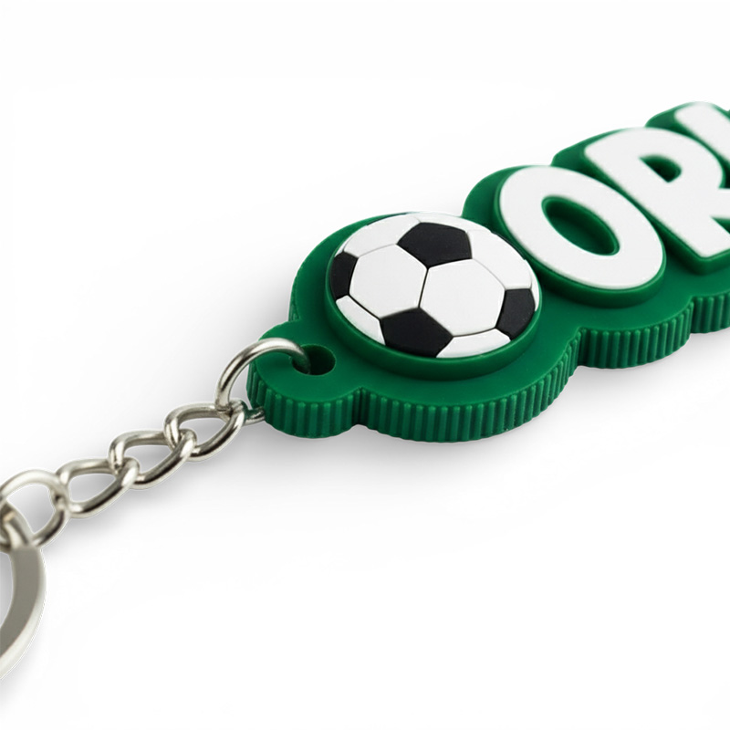 3D keychain with the text "Orlik", sports-themed, featuring a football, white and green, close-up on 3D edge patterns, Polish producer DECARD