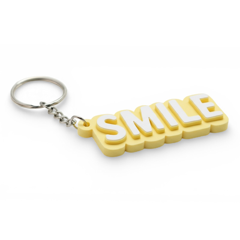 3D keychain with the text "Smile", yellow and white, Polish producer DECARD