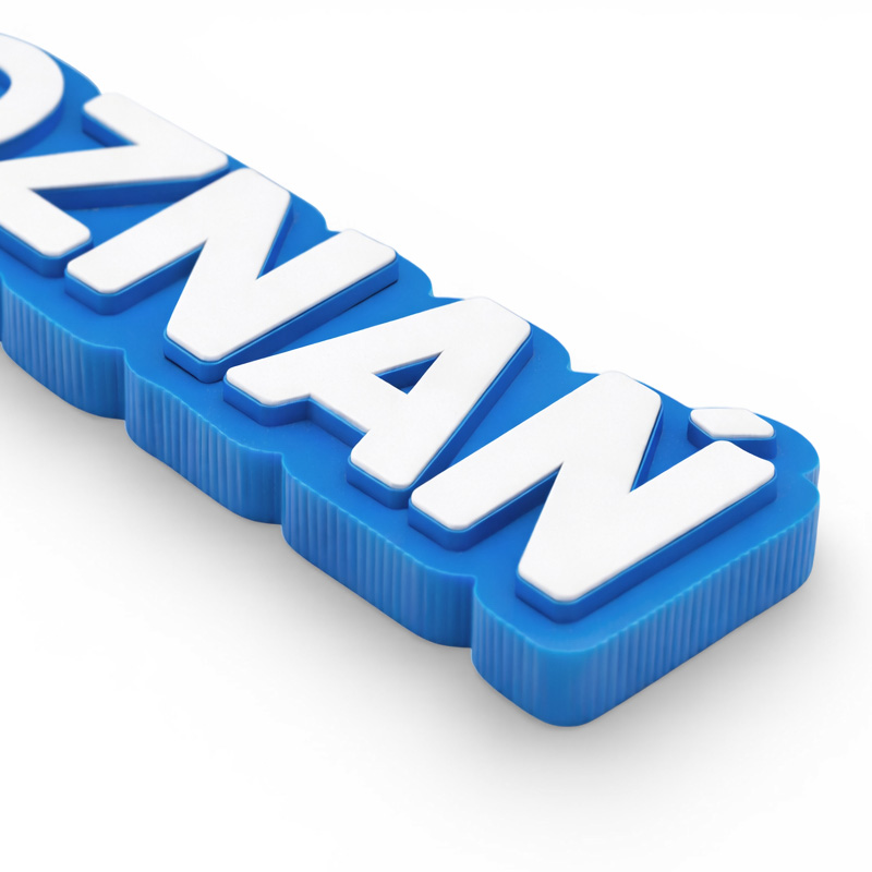 3D keychain with the text "Poznań", blue and white, with the city crest, close-up on raised lettering, Polish producer DECARD
