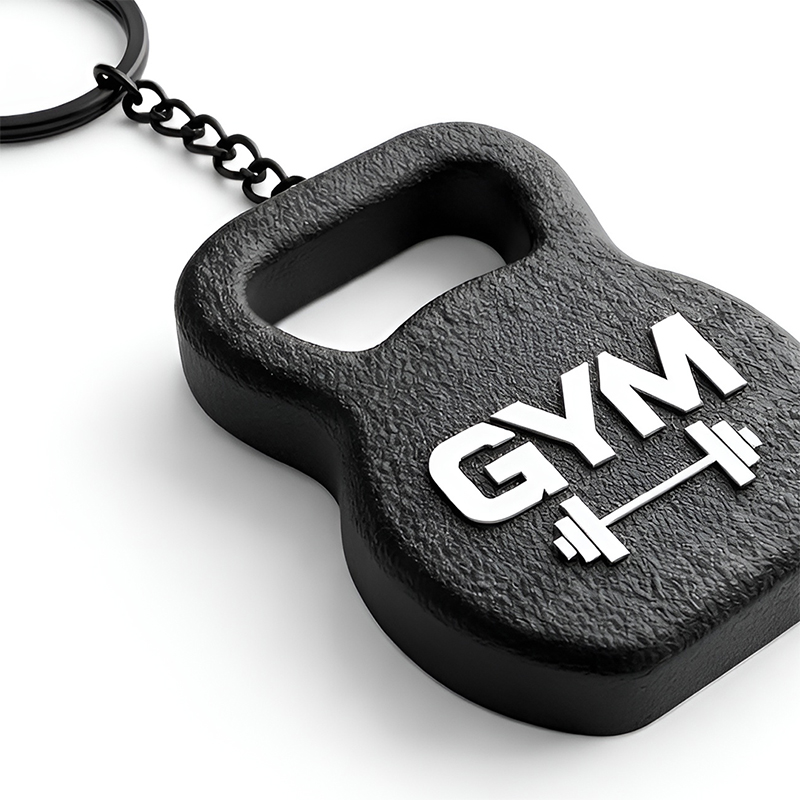 A 3D kettlebell-shaped keychain in black and white, featuring a raised texture and a QR code on the front, with a close-up highlighting the details, manufactured by the Polish producer DECARD