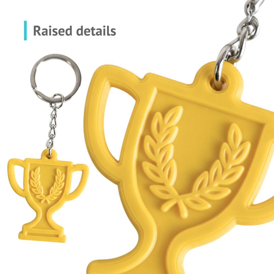 Yellow pastel trophy keychain, close-up of raised details, resin, made by Polish manufacturer DECARD