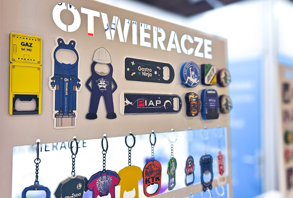 Close-up of bottle openers attached to a metal board at the DECARD booth during PROMO SHOW 2026