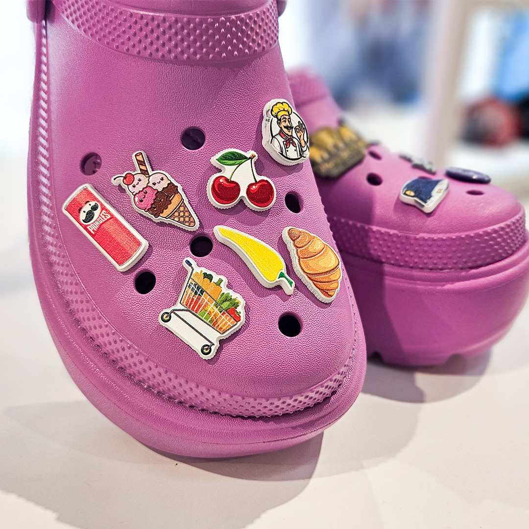 Colorful fruit charms on pink Crocs, made by Polish manufacturer DECARD