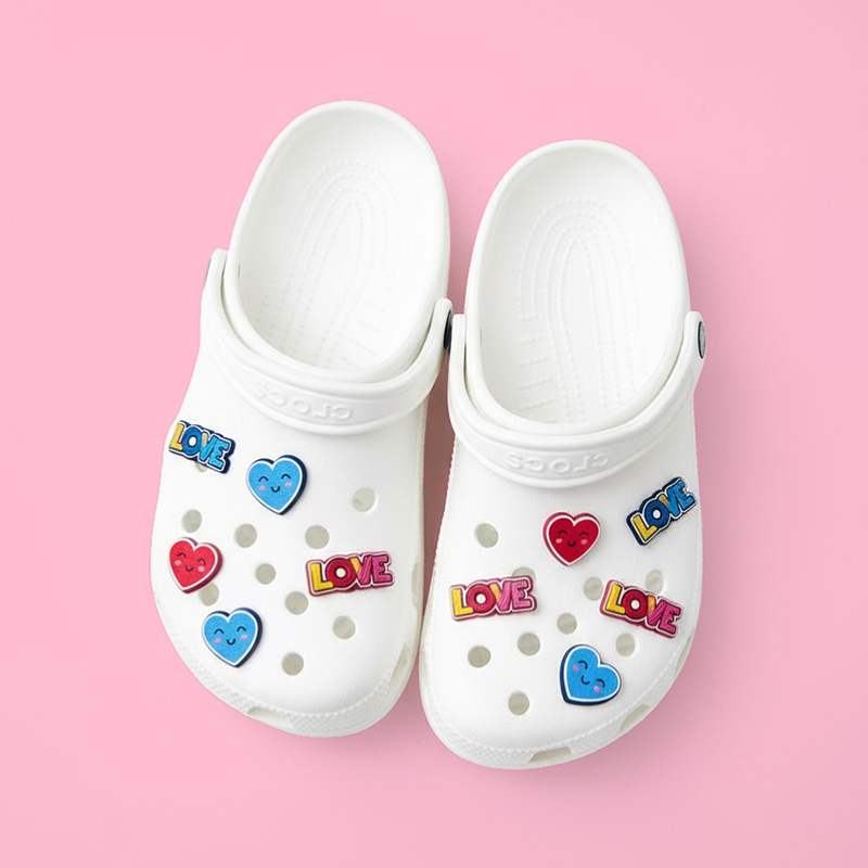 Colorful Crocs charm in the shape of a heart and the word LOVE, made from raised resin and attached to white Crocs, highlighting fine details and vibrant colors. Manufactured in Poland by DECARD
