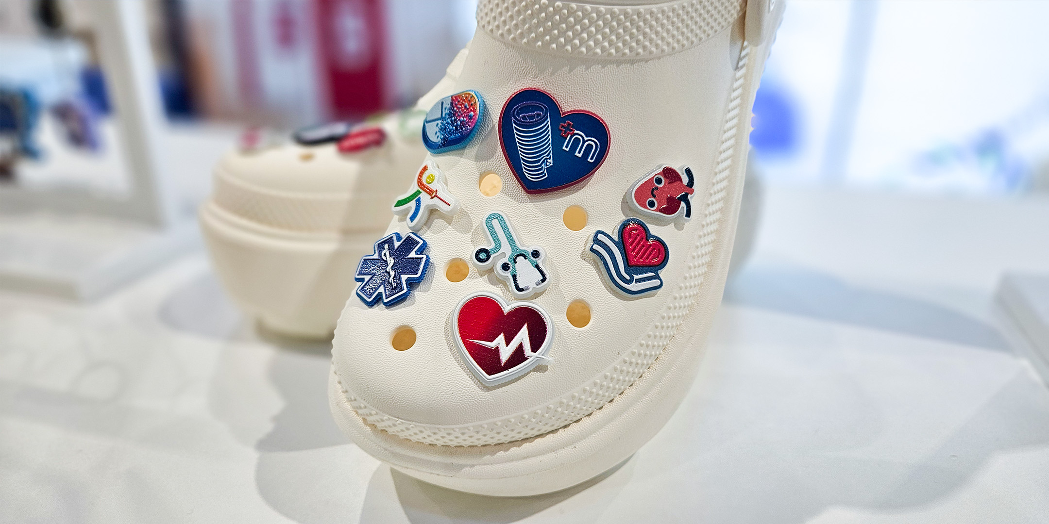 Medical-themed charms on white Crocs, made by Polish manufacturer DECARD