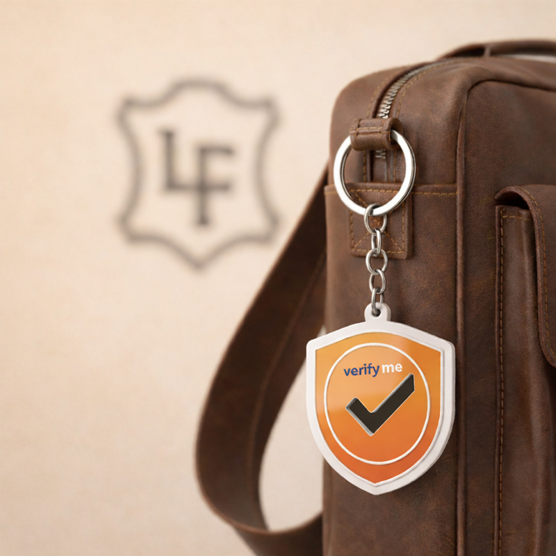 Metal keychain with a cutout, shield shape, hanging on a brown sports bag, made by the Polish manufacturer DECARD