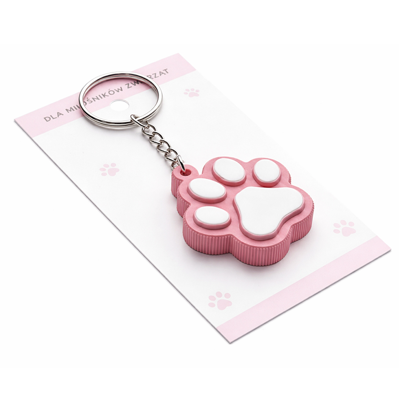 A 3D keychain in the shape of an animal paw, made of hard resin, with vivid pastel colors and a dedicated backing card, featuring decorative 3D patterns along the edges. Manufactured in Poland by DECARD