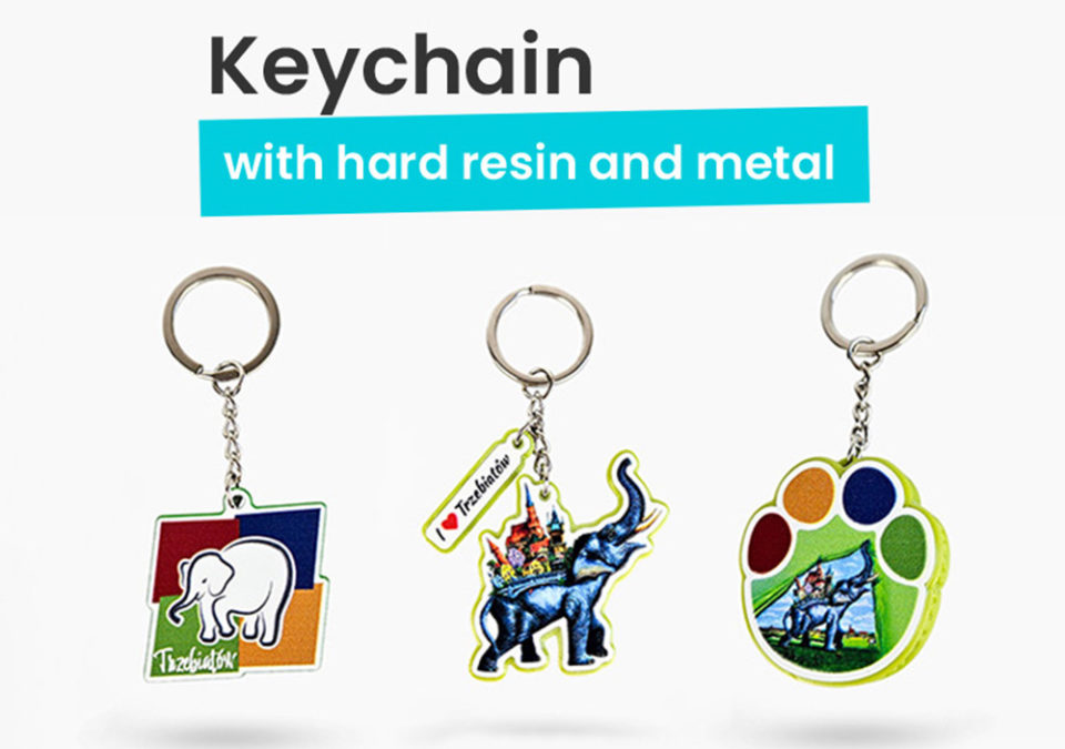 3 types of keychains: a metal keychain with a printed elephant, a hard resin elephant-shaped keychain with a hanging tag, and an elephant paw keychain with a bottle opener function. Produced by Polish manufacturer DECARD