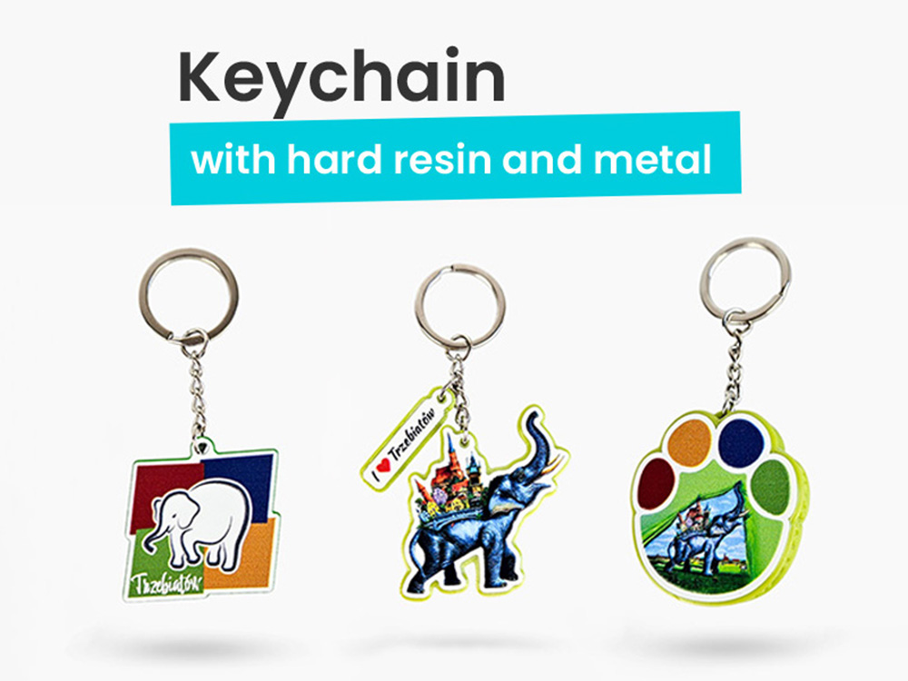 3 types of keychains: a metal keychain with a printed elephant, a hard resin elephant-shaped keychain with a hanging tag, and an elephant paw keychain with a bottle opener function. Produced by Polish manufacturer DECARD