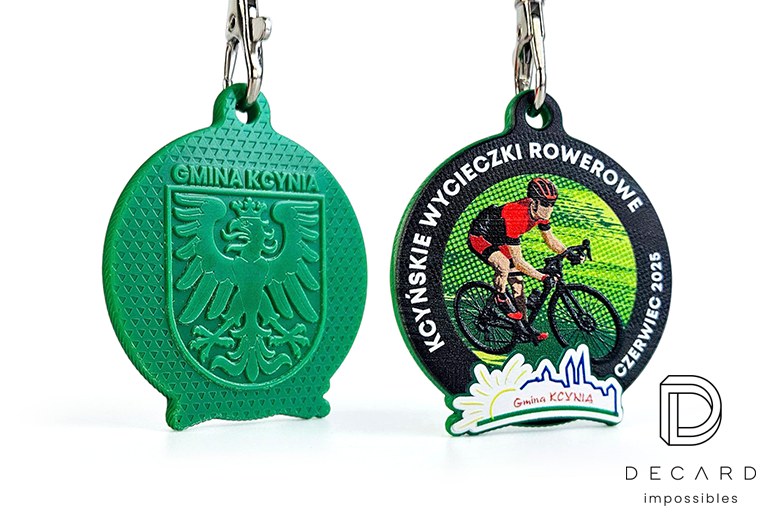 Custom sports medals with a raised cyclist motif on the front and detailed 3D coat of arms engraving on the back, proudly produced by DECARD, a Polish manufacturer