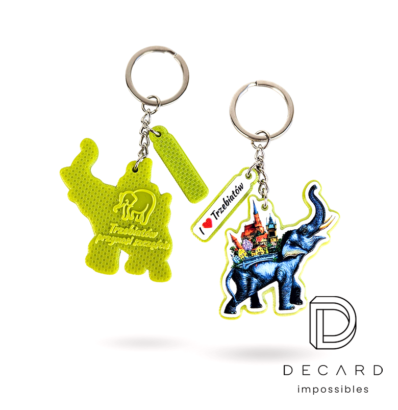 Elephant keychain, with a colorful graphic on the front, a raised logo on the back, and an “I love Trzebiatów” charm, made by the Polish manufacturer DECARD