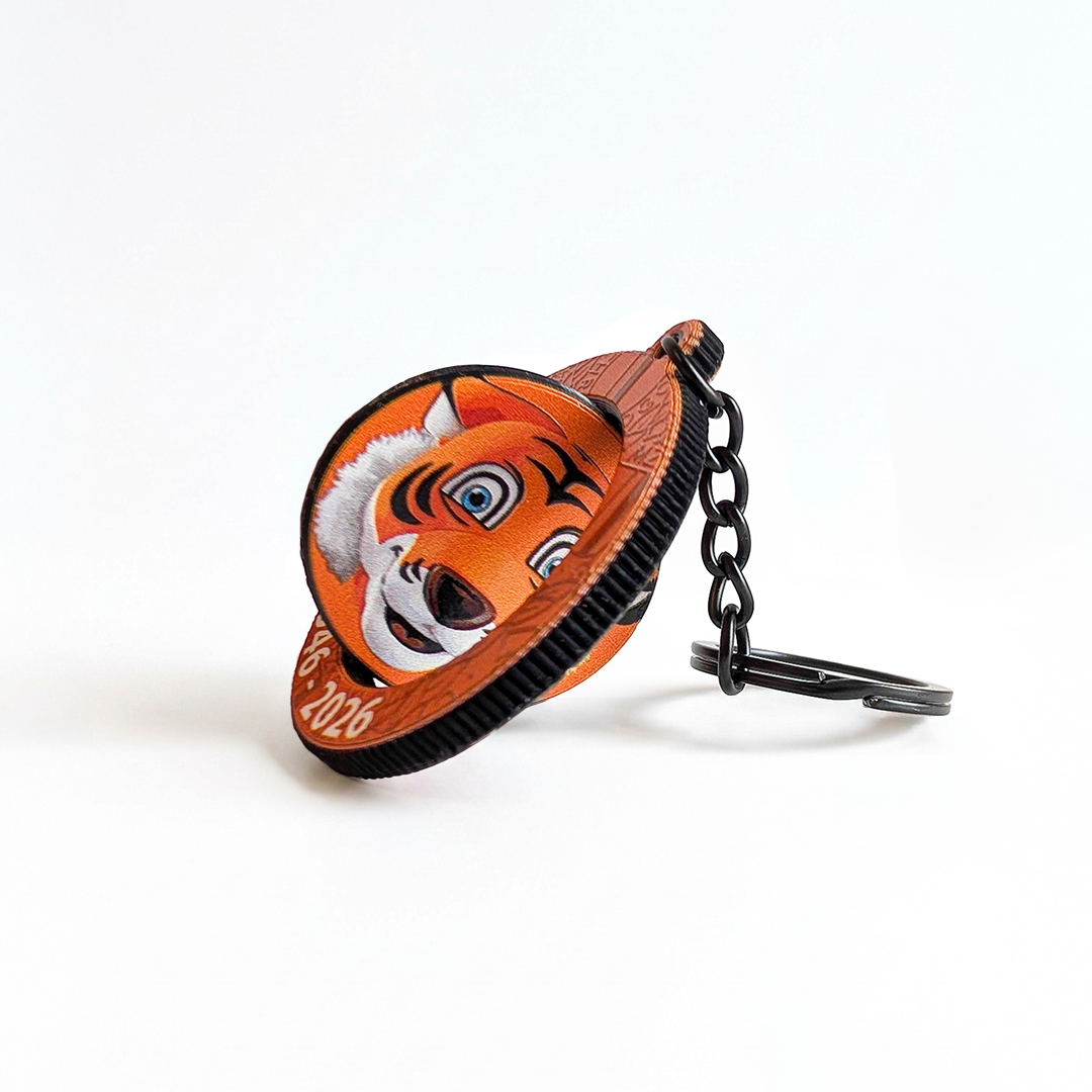 Side view of a rotating tiger keychain shown in motion during rotation. Manufactured by Polish promotional merchandise producer DECARD