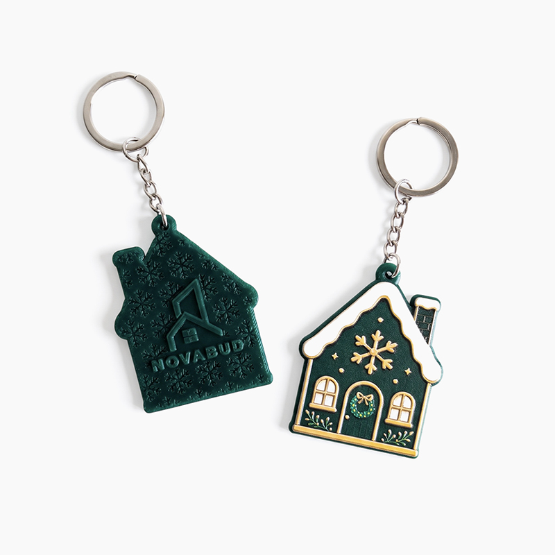 Christmas house keychains, featuring graphics on the front and a raised logo on the back, made in Poland by DECARD