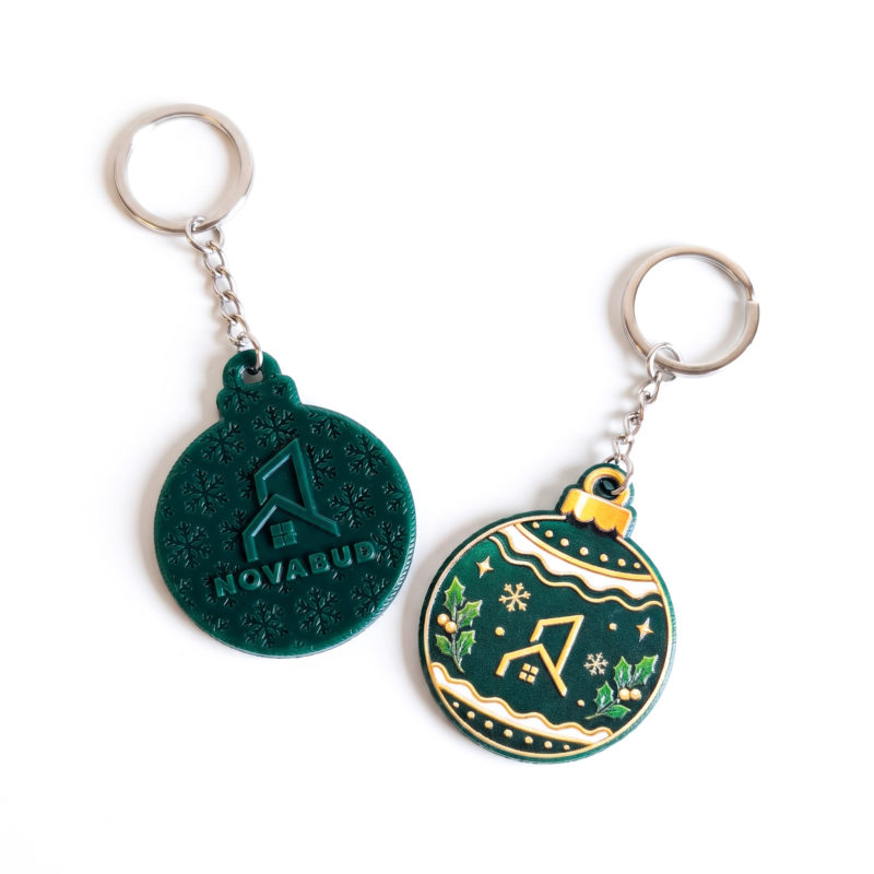 Christmas bauble keychain with a slightly raised graphic on the front and a raised logo on the back, made in Poland by DECARD