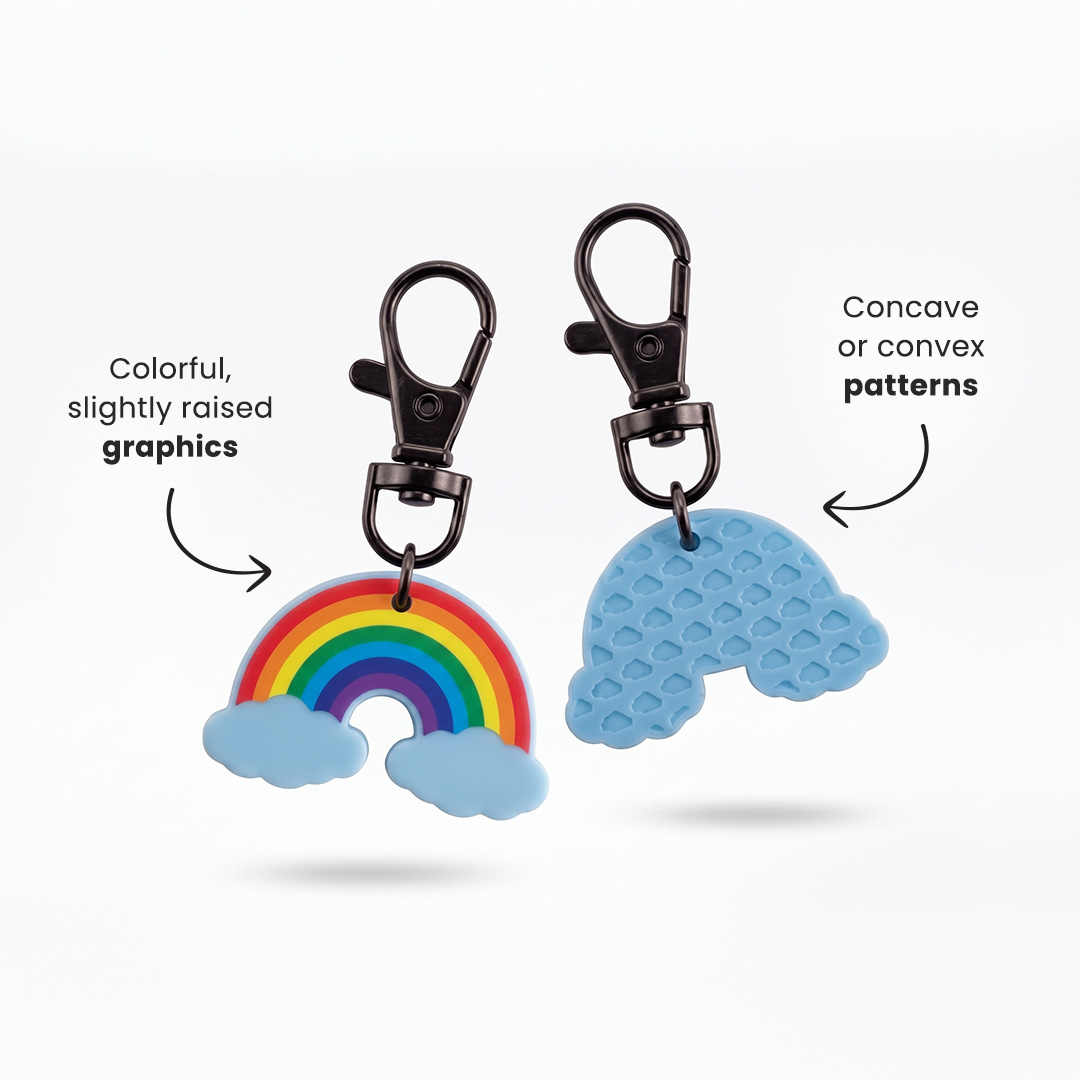 Rainbow keychain with a carabiner, featuring a slightly raised full-colour design on the front and raised or recessed patterns on the back. Made in Poland by DECARD