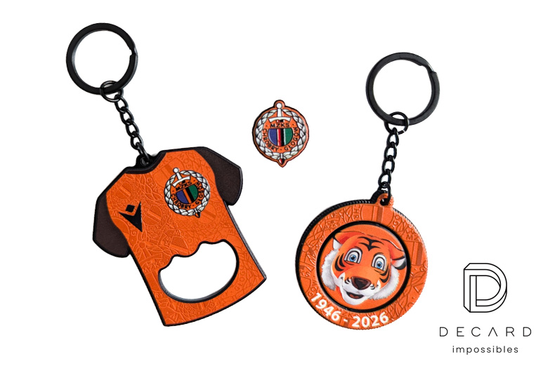 Sports set: metal T-shirt-shaped keychain with a bottle opener function, rotating resin keychain with the club mascot (tiger cub), and a pin with the club logo